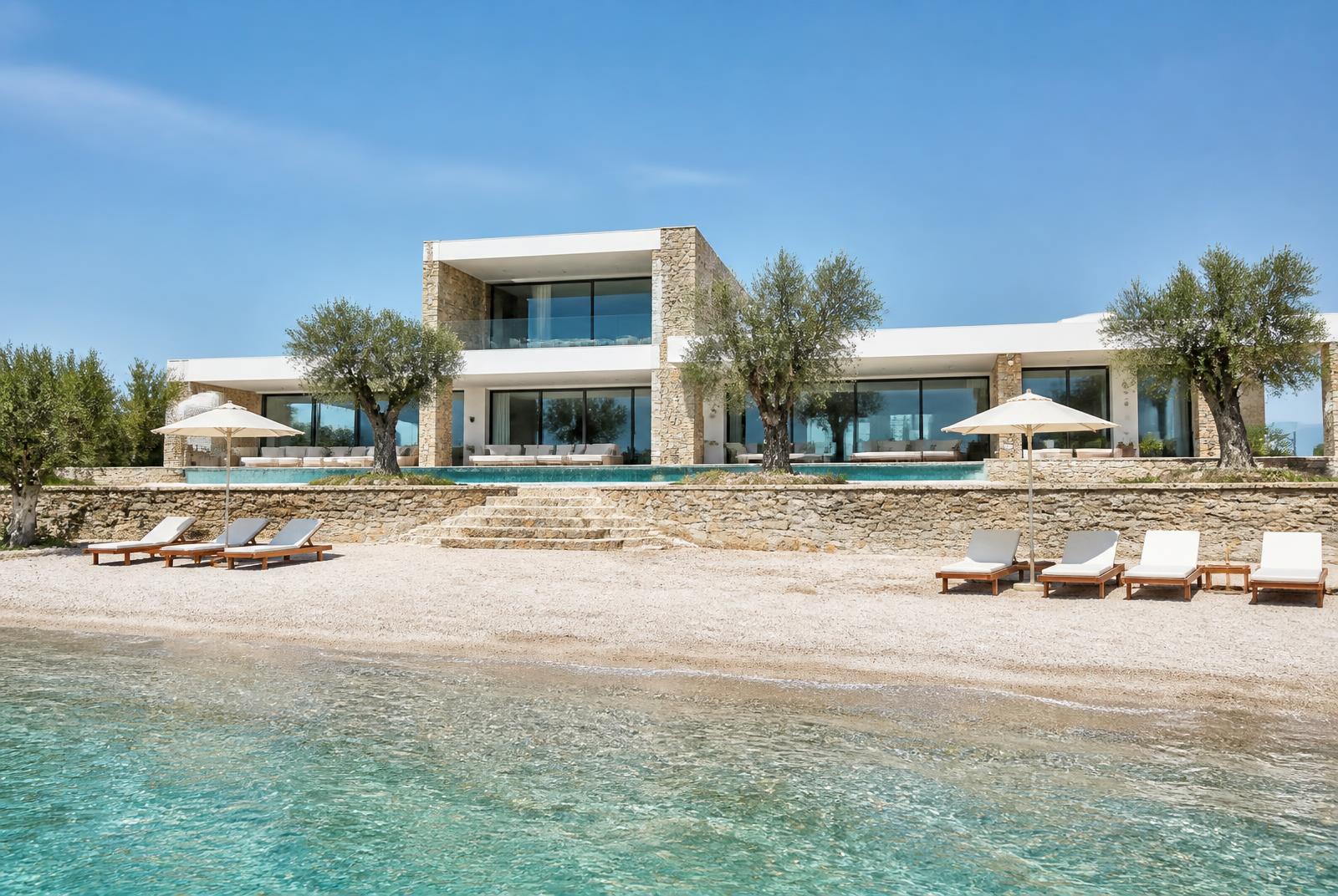 Private beach and turquoise water in front of the villa